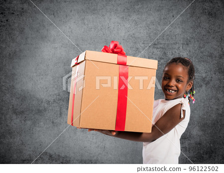 Happy little girl with a Christmas gift Happy little girl with a Christmas gift 96122502