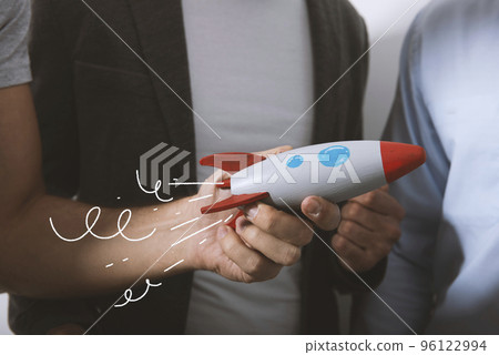 Businessman launches his startup company with a rocket Businessman launches his startup company with a rocket 96122994