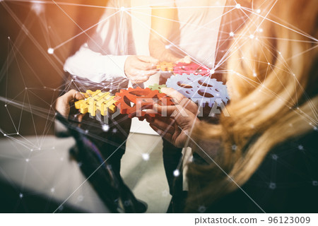 Business team connect pieces of gears. Teamwork, partnership and integration concept. double exposure with network effects Business team connect pieces of gears. Teamwork, partnership and integration concept. double exposure with network effects 96123009