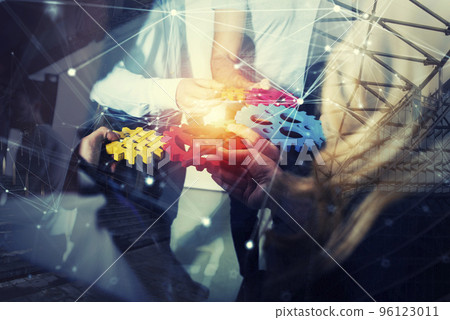 Business team connect pieces of gears. Teamwork, partnership and integration concept. double exposure with network effects 96123011