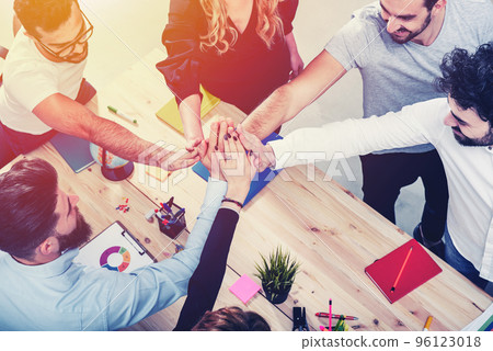 Business people putting their hands together. Concept of integration, teamwork and partnership Business people putting their hands together. Concept of integration, teamwork and partnership 96123018