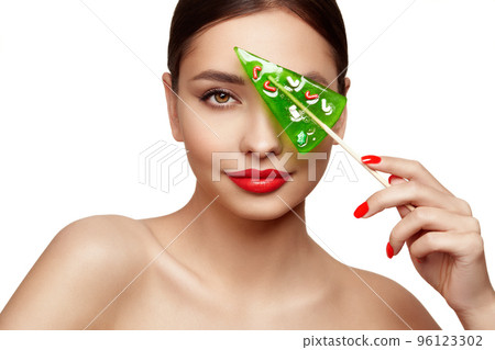 Beauty model girl eating Christmas tree shape lollipop 96123302