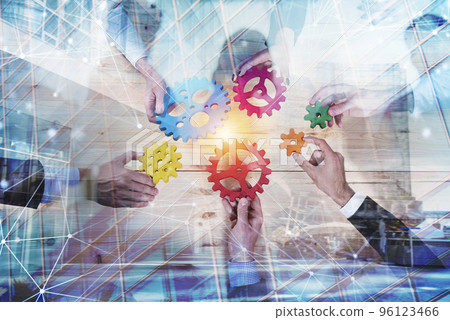 Business team connect pieces of gears. Teamwork, partnership and integration concept with network effect. double exposure 96123466