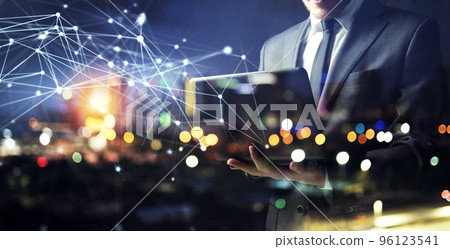 Businessman works with his laptop during the night. double exposure 96123541