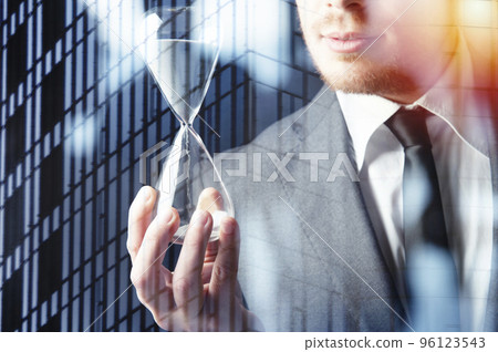 Businessman holding a hourglass. Concept of deadline in business 96123543
