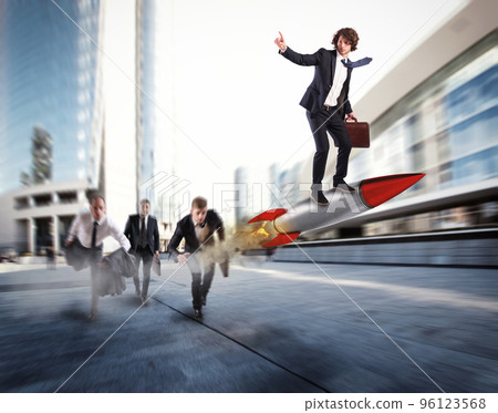 Push to reach the goals before the others. Businessman wins a challenge riding a rocket Push to reach the goals before the others. Businessman wins a challenge riding a rocket 96123568