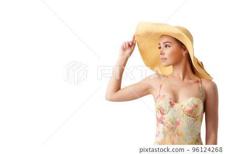 Girl with hat at the beach with a bright sea 96124268