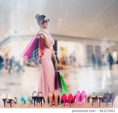 Girl full of bags does shopping in a store 96125061