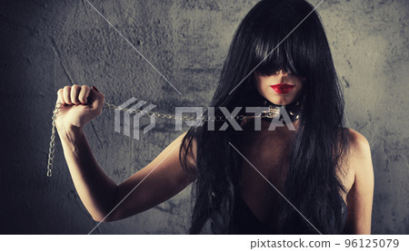 Sensual provocation of a sexy bdsm woman with chained neck 96125079