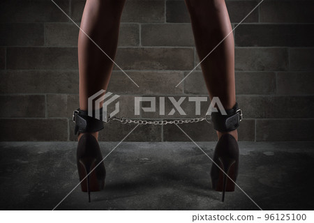 Sensual provocation of a sexy bdsm woman with chained legs 96125100
