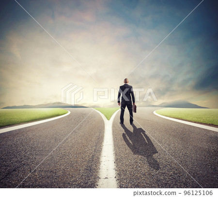 Businessman in front of a crossway must select the right way 96125106
