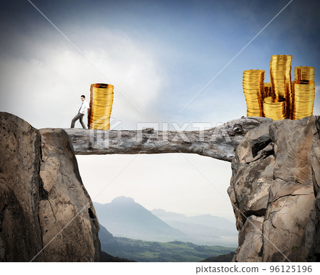 Businessman moves a pile of coins to a moneybox. concept of difficulty to saving money 96125196