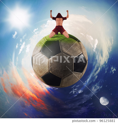 Football player exults in a soccer ball planet Football player exults in a soccer ball planet 96125881