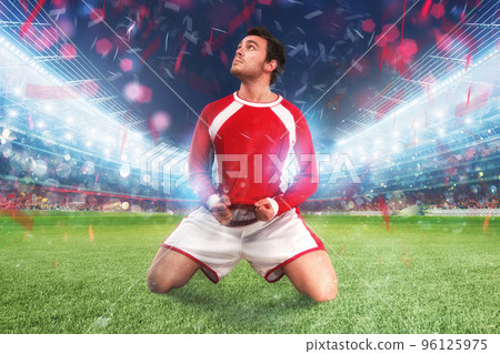 Football player exults in a full stadium Football player exults in a full stadium 96125975