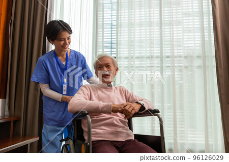 Friendly staff caregiver of nursing home talking to asian senior man in living room Friendly staff caregiver of nursing home talking to asian senior man in living room 96126029