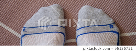 Male feet in socks standing on yoga mat closeup top view Male feet in socks standing on yoga mat closeup top view 96126731