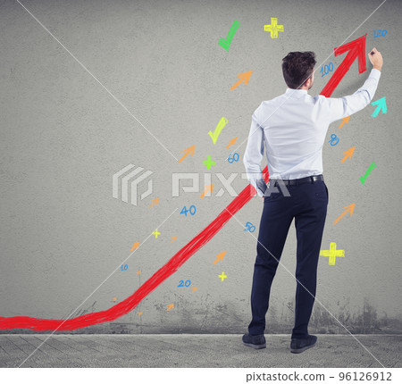 Businessman draws positive statistics of his company. Concept of success Businessman draws positive statistics of his company. Concept of success 96126912