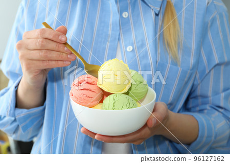 Concept of summer food, woman eats ice cream Concept of summer food, woman eats ice cream 96127162