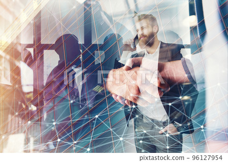 Handshaking business person in office with network effect. concept of teamwork and partnership. double exposure Handshaking business person in office with network effect. concept of teamwork and partnership. double exposure 96127954