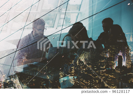 Businessmen that work together in office with network connection effect. Concept of teamwork and partnership. double exposure Businessmen that work together in office with network connection effect. Concept of teamwork and partnership. double exposure 96128117