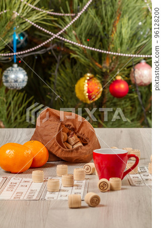Cup of coffee, oranges and lotto barrels with bag, game cards for a game in lotto. 96128200