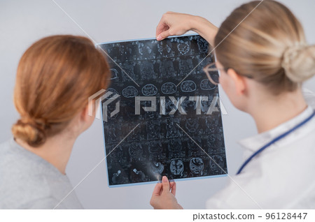 Female doctor explaining mri of internal organs to female patient.  96128447