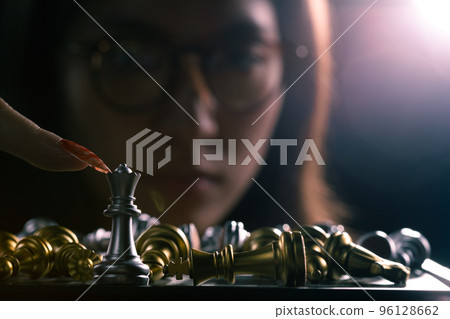 Business woman play queen Chess with close up finger nail. Leader use strategy game to challenge competitor with leadership to move Queen to victory with management team idea fight last stand Business woman play queen Chess with close up finger nail. Leader use strategy game to challenge competitor with leadership to move Queen to victory with management team idea fight last stand 96128662