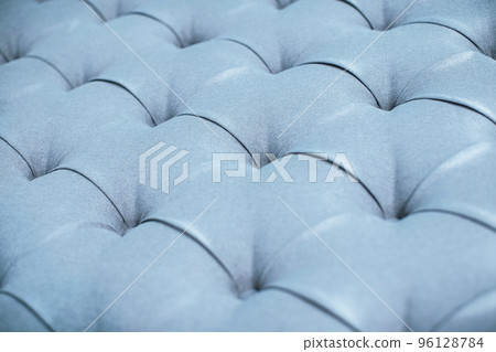 Blue gray upholstered furniture from ement quilted fabric texture. Interior design, headboards made of furniture fabric upholstery. Classic checkered pattern background for furniture, wall, headboard 96128784
