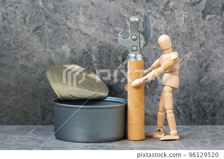 Dummy holding can opener and standing next to open tin can 96129520