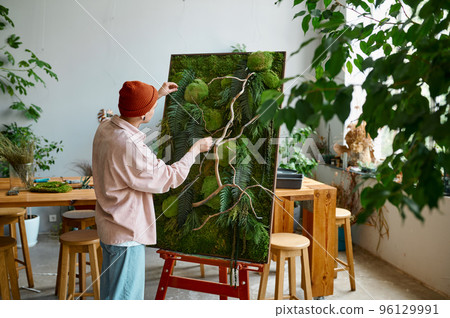 Young hipster man designer creating floral composition at art studio Young hipster man designer creating floral composition at art studio 96129991