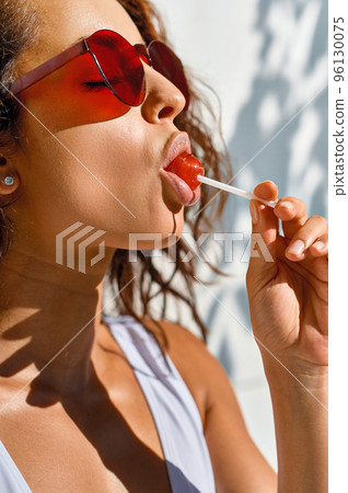 Attractive woman with lollipop closeup 96130075