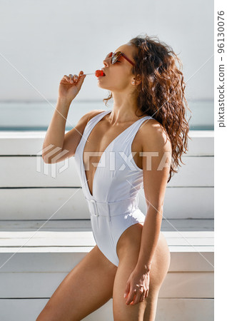 Portrait of trendy fashion woman with lollipop Portrait of trendy fashion woman with lollipop 96130076
