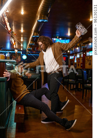 Unhappy furious friends fighting at pub 96130131