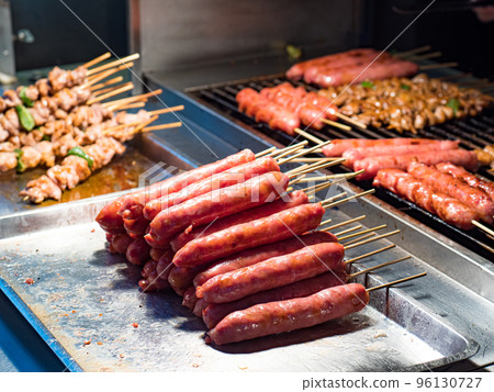 Cooking shish kebab on skewers. Meat, vegetables and chinese sausage. Cooking shish kebab on skewers. Meat, vegetables and chinese sausage. 96130727