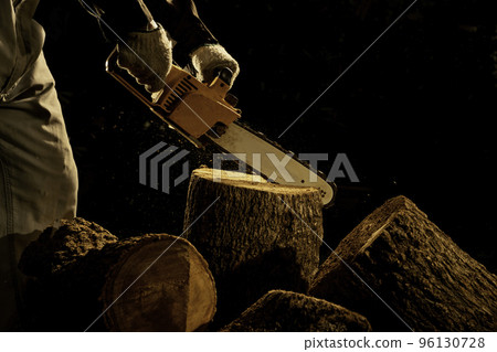 electric chainsaws cut trees in the forest for building a house and making firewood The concept of deforestation electric chainsaws cut trees in the forest for building a house and making firewood The concept of deforestation 96130728