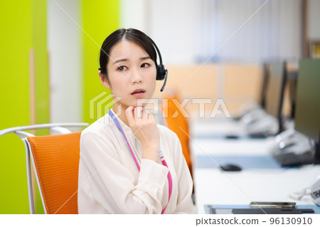A young woman of an operator working at a call center (worried, troubled) A young woman of an operator working at a call center (worried, troubled) 96130910