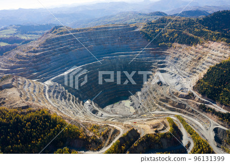 Flying above an open pit mine, copper excavation in Rosia Poieni, Romania. Aerial view 96131399
