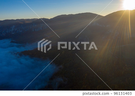 Aerial view of morning fog in the valley in dawn Aerial view of morning fog in the valley in dawn 96131403