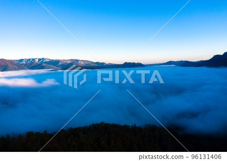Aerial view of mist and clouds in the valley in sunrise Aerial view of mist and clouds in the valley in sunrise 96131406