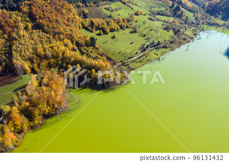 Aerial view of green mine waters from a copper mine flooding natural habitat 96131432