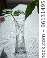 Variety of flowers in a vase on a wooden table in a vintage style room 96131495