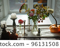 Variety of flowers in a vase on a wooden table in a vintage style room 96131508