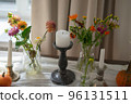 Variety of flowers in a vase on a wooden table in a vintage style room 96131511