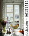 Variety of flowers in a vase on a wooden table in a vintage style room 96131512