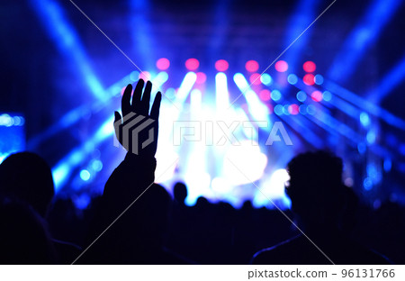Silhouette of concert crowd in front of bright stage lights Silhouette of concert crowd in front of bright stage lights 96131766