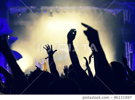 Crowd at a music concert, audience raising hands up 96131997