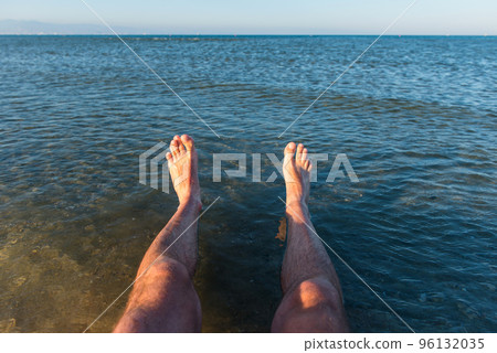 Sea waves washing man's feet Sea waves washing man's feet 96132035