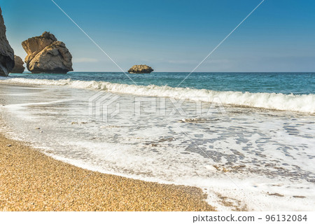 Waves wash over golden sand 96132084