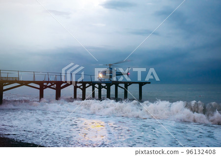 Helicopter landing during a sea storm Helicopter landing during a sea storm 96132408