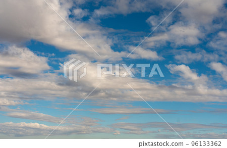 Clouds rising from the horizon in the blue sky Clouds rising from the horizon in the blue sky 96133362